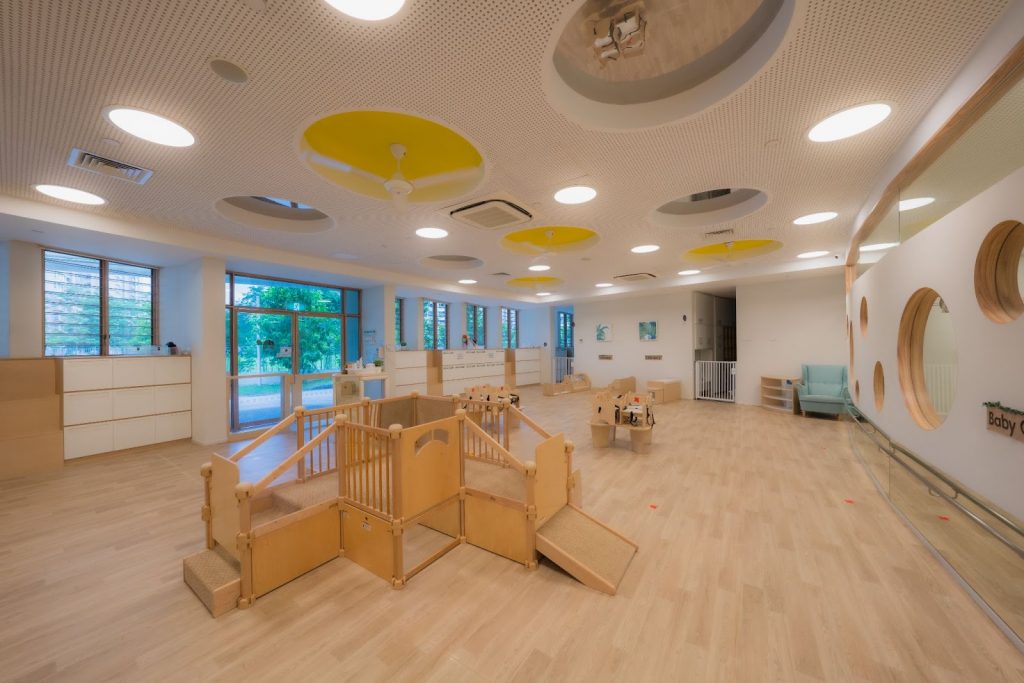 Multiple exit doors and scaled-down play areas within the preschool. 
