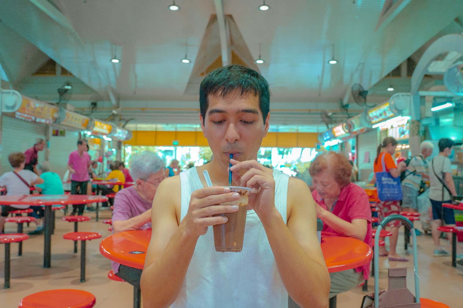Ashish Kumar sips on an iced coffee at a hawker centre. Oh, the joys of early retirement. 